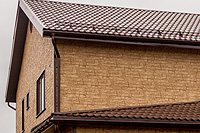 Фасад дома, отделанный сайдингом Гранд Лайн, цвет Янтарный